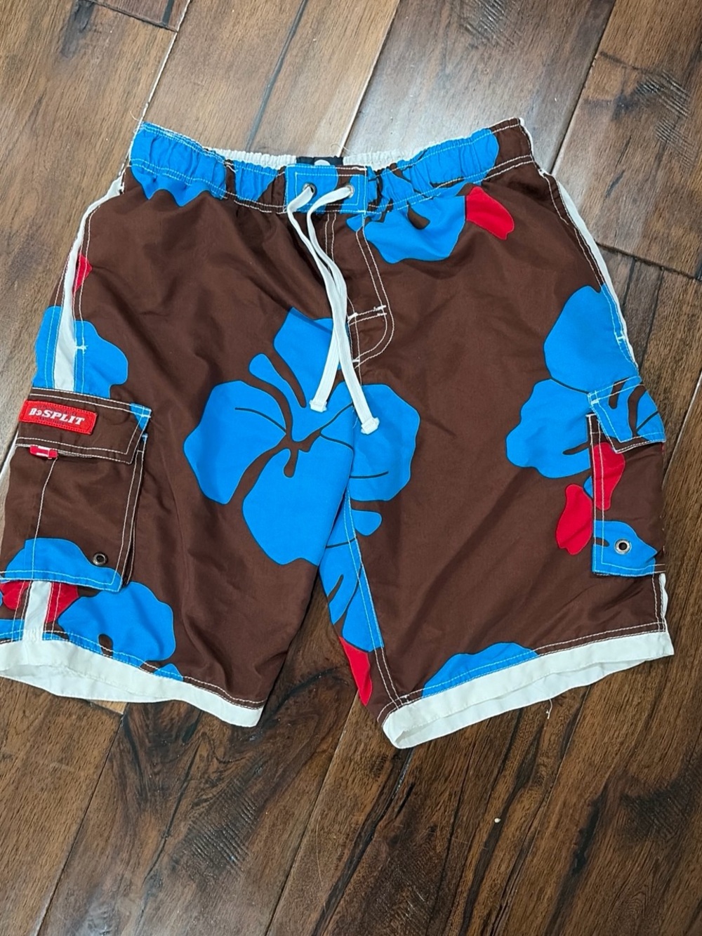 split Brown Swim Board Shorts with Blue Floral and Red Accents